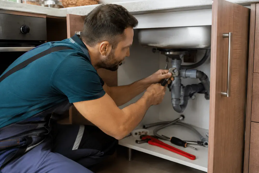 Plumber Buffalo Grove IL fixing a kitchen sink pipe